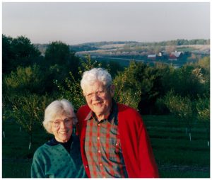 The late Tom and Louise Lawton, with their farm in the distance.